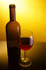 Still-life with glass and bottle of red wine