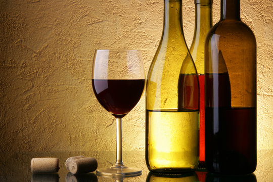 Fototapeta Still-life with three wine bottles and glass