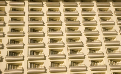 Rows of identical balconies on a white high rise resort hotel