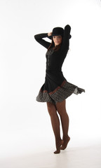 The dancing girl in a black dress on a white background