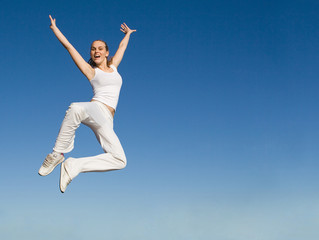 Obraz premium happy smiling successful woman jumping with joy