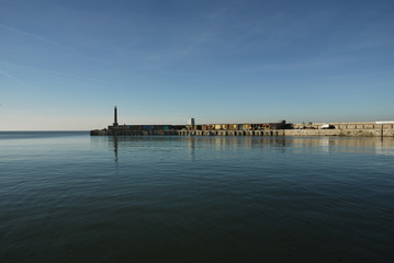 View across a calm sea of Margate harbor in Kent, UK.