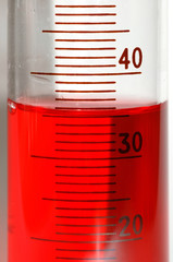 A 100ml measuring cylinder containing red liquid