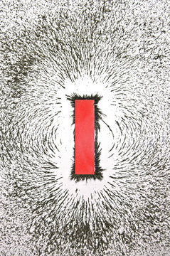 Bar magnet with iron filings showing magnetic field pattern