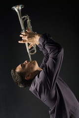 Man in shirt trumpet melody. Side view.