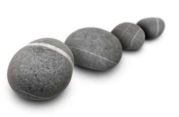 four stones aligned on white background