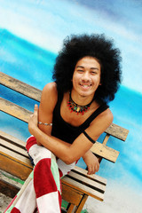Happy young Thai man with an afro.