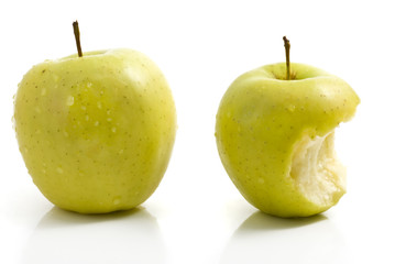Green apple and apple with bite on white background