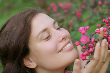 Girl holds pink flowers and smile - very cute portrait