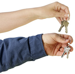 Man and woman hand over keys isolated on a white background. 