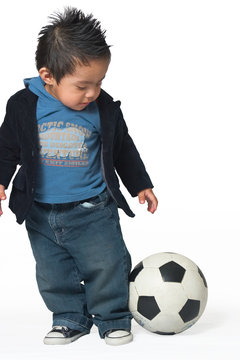 hispanic boy with soccer ball
