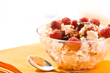 Glass bowl with soft cheese and raspberry