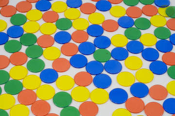 Colourfull Counters on a white background, mixed up colours