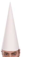 Man in a dunce cap over a white background