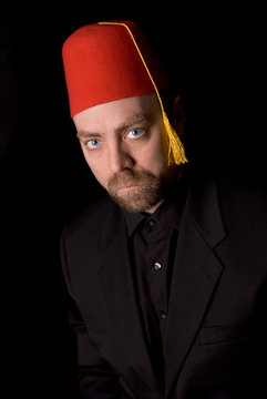 Man Wearing A Red Shriners Fez Over A Black Background