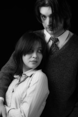 young couple isolated on black, black and white