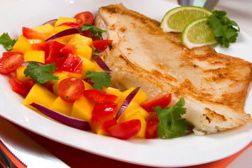 Fried skate (ray) with mango, cherry tomato red onion salsa.