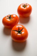 A shot of three ripe and juicy tomatoes