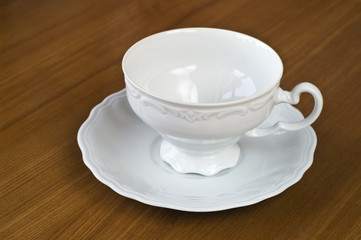 Empty white cup on wooden oak table
