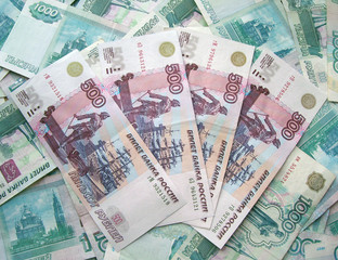 The background is a lot of banknotes of Russia