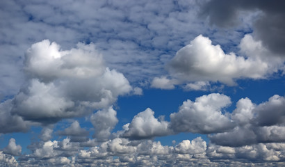 Clouds up to horizon. Dark blue color.