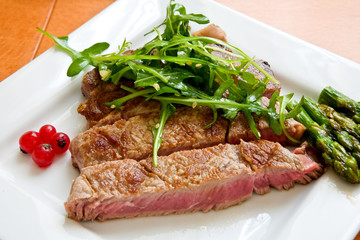 grilled beef steak with green salad and asparagus