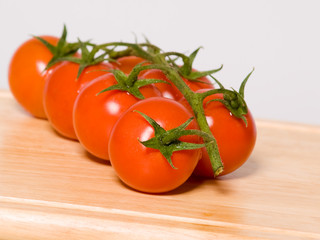 cluster of red cherry tomatoes on the vine