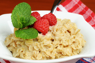 Bowl of hot oatmeal with fresh raspberries.
