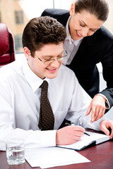 Fototapeta premium Portrait of two business people planning a schedule of works
