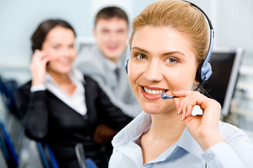 Closeup of smiling beautiful business woman with headset 