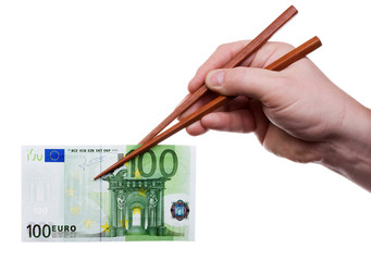 Hand holding chopsticks with banknote. with clipping path