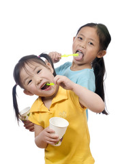 Two sisters brushing thier teeth. Health and living.