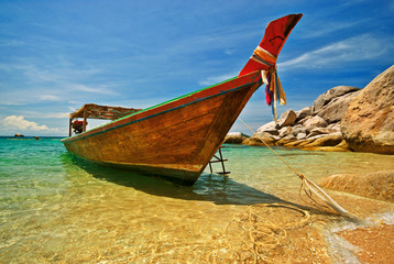 Longtail boat anchored at a beach
