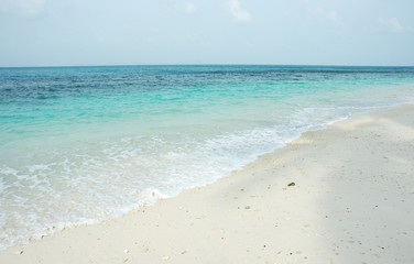 Fototapeta na wymiar clean beach with white sand and blue sky