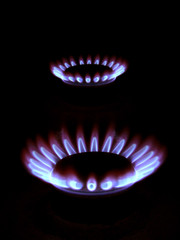Blue flames of gas stove in the dark
