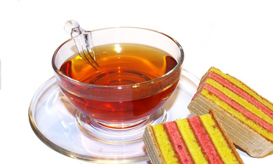 Transparent cup of tea and cookies on a white background
