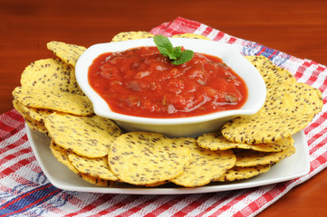 White bowl of fresh salsa served with tortilla chips.