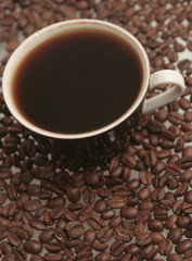 The black cup with fragrant coffee costs on a table