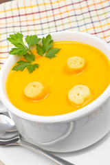 Carrots puree with bread croutons over squared mat. Shallow DOF