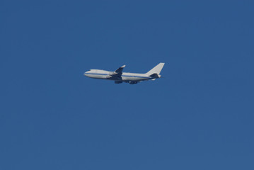 Naklejka na ściany i meble Jet Plane in the Blue Sky