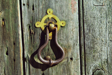 Detail of a vintage weathered door with rusty handle