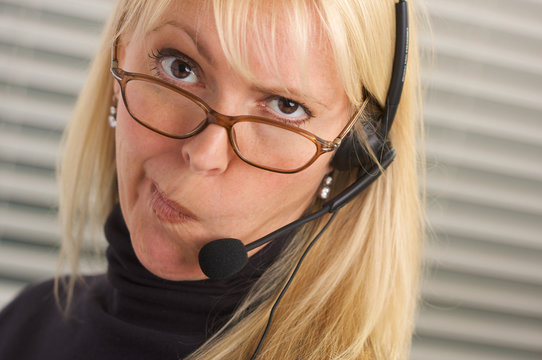 Exasperated Cross Businesswoman Wearing a Phone Headset