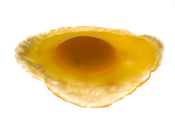 Fried egg sitting on white light table