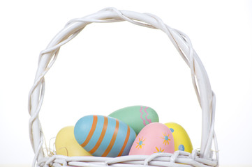 Close-up of Easter eggs in a white wicker  basket 