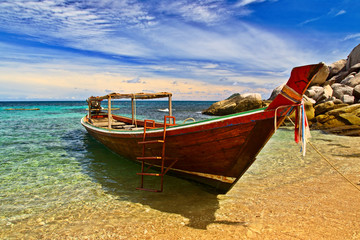 Longtail boat in tranquil bay