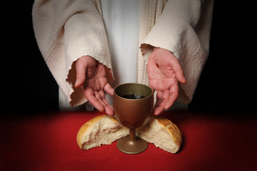 The hands of Jesus offering the Communion wine and bread - 6302188