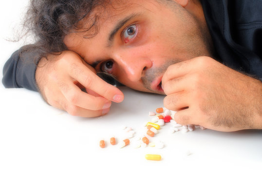 Man eating capsule of drugs for stay alert .