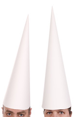 Man and woman in dunce caps over a white background