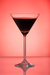 Pomegranate cocktail on red background