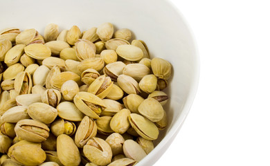 bowl of pistachios close-up over white